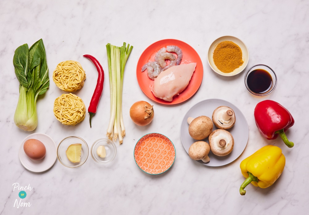 The ingredients for Pinch of Nom's Singapore-Style Noodles are laid out on a kitchen countertop, ready to begin cooking.