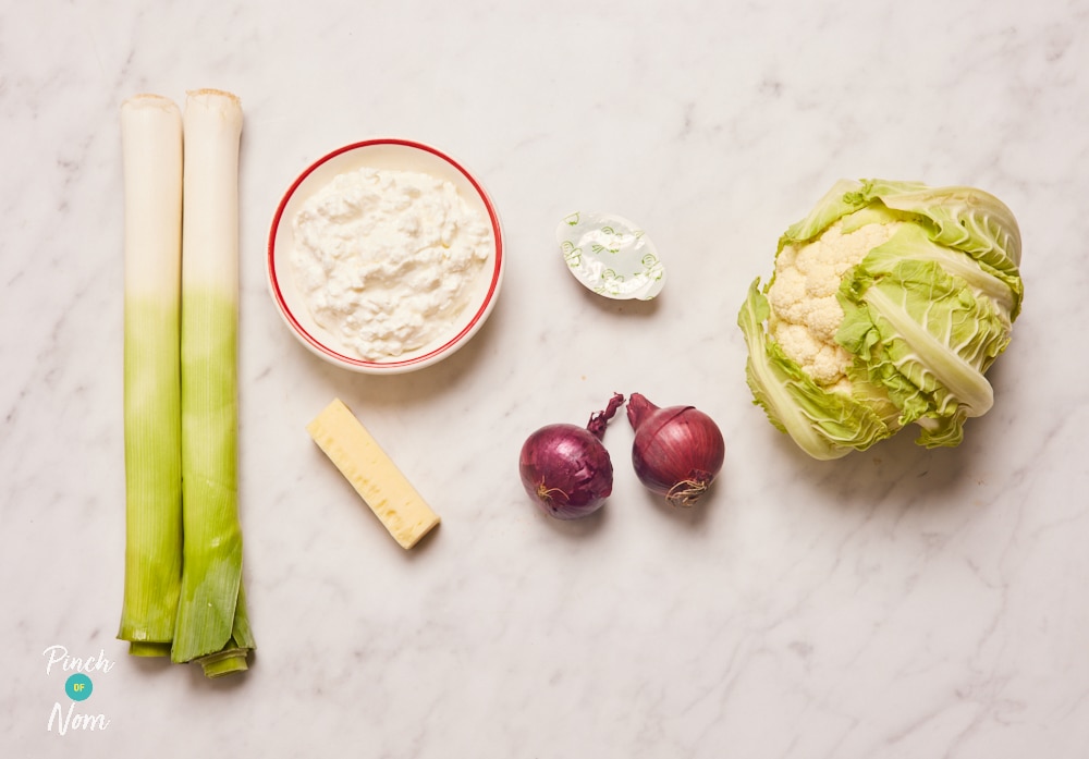 The ingredients for Pinch of Nom's slimming-friendly Cauliflower Cheese are laid out on a kitchen surface, ready to begin cooking.