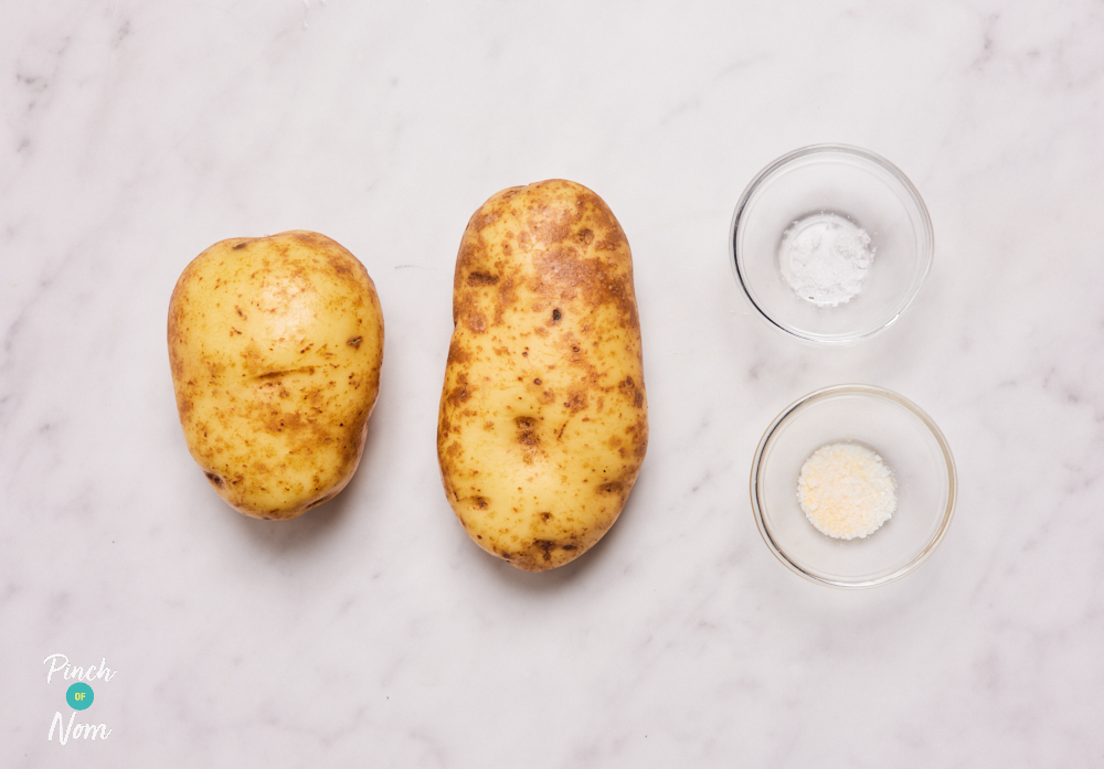 The ingredients for Pinch of Nom's Zinger Chunky Chips are laid out on a kitchen countertop. Each ingredient is weighed out in a separate container, ready to begin cooking.