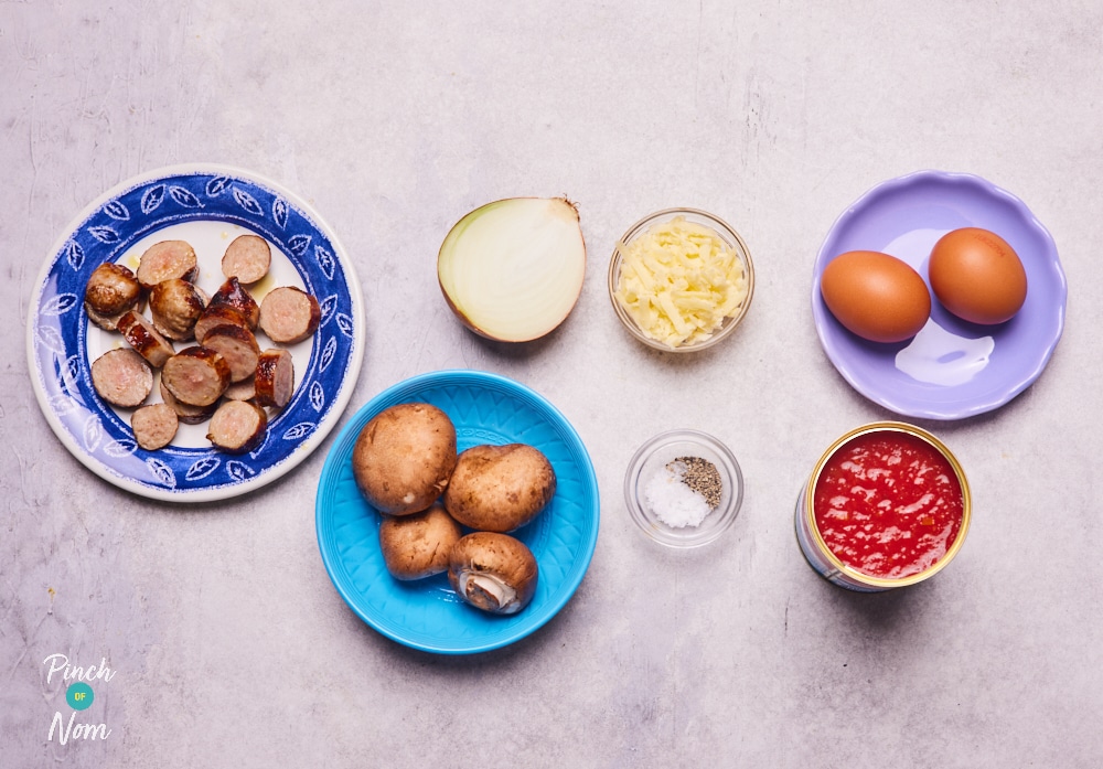 The ingredients for Pinch of Nom's Sausage, Mushroom and Tomato Breakfast Bake are laid out on a kitchen counter, ready to begin cooking.