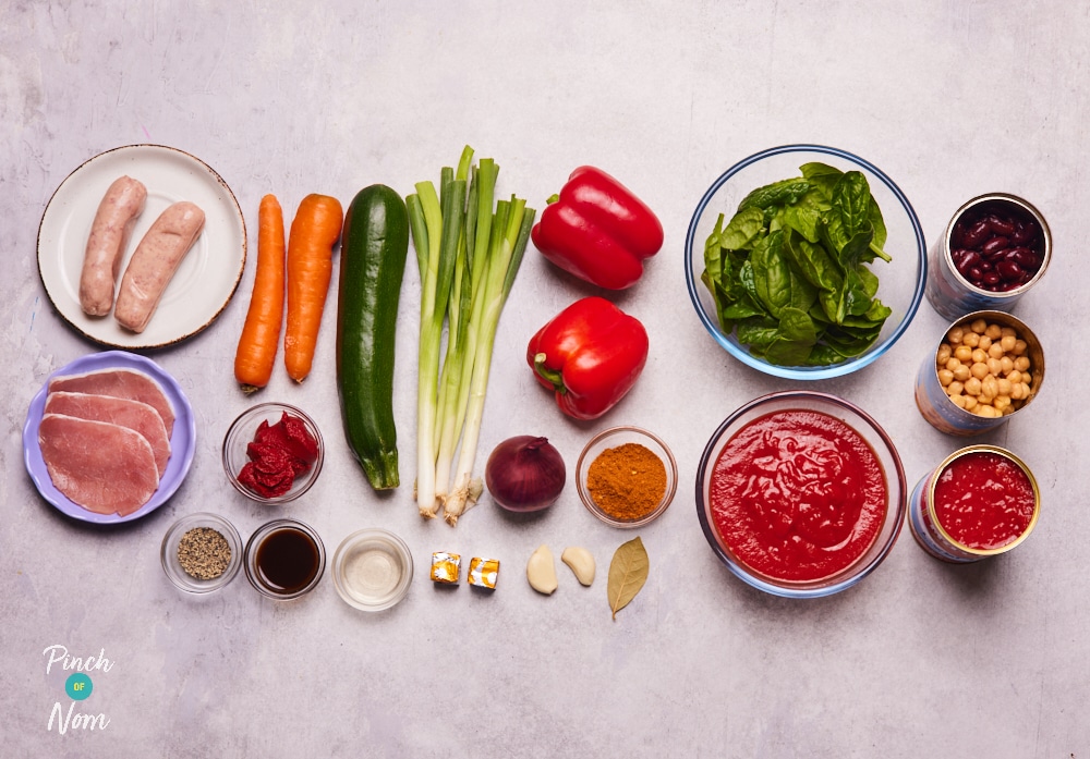 The ingredients for Pinch of Nom's Slow Cooker Chunky Tomato Cajun-Style Soup are laid out on a kitchen counter, ready to begin cooking.