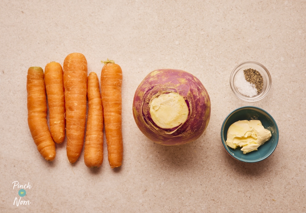 Ingredients for Buttery Carrot and Swede Mash laid out on counter.