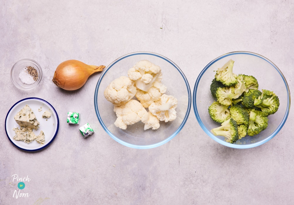 The ingredients for Pinch of Nom's Cauliflower and Broccoli Soup are laid out on a kitchen counter, ready to begin cooking.