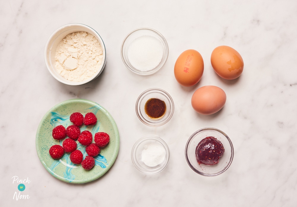 The ingredients for Pinch of Nom's Mini Victoria Sponge Cakes are laid out on a kitchen counter. Each ingredient is measured and portioned out, ready to begin baking.