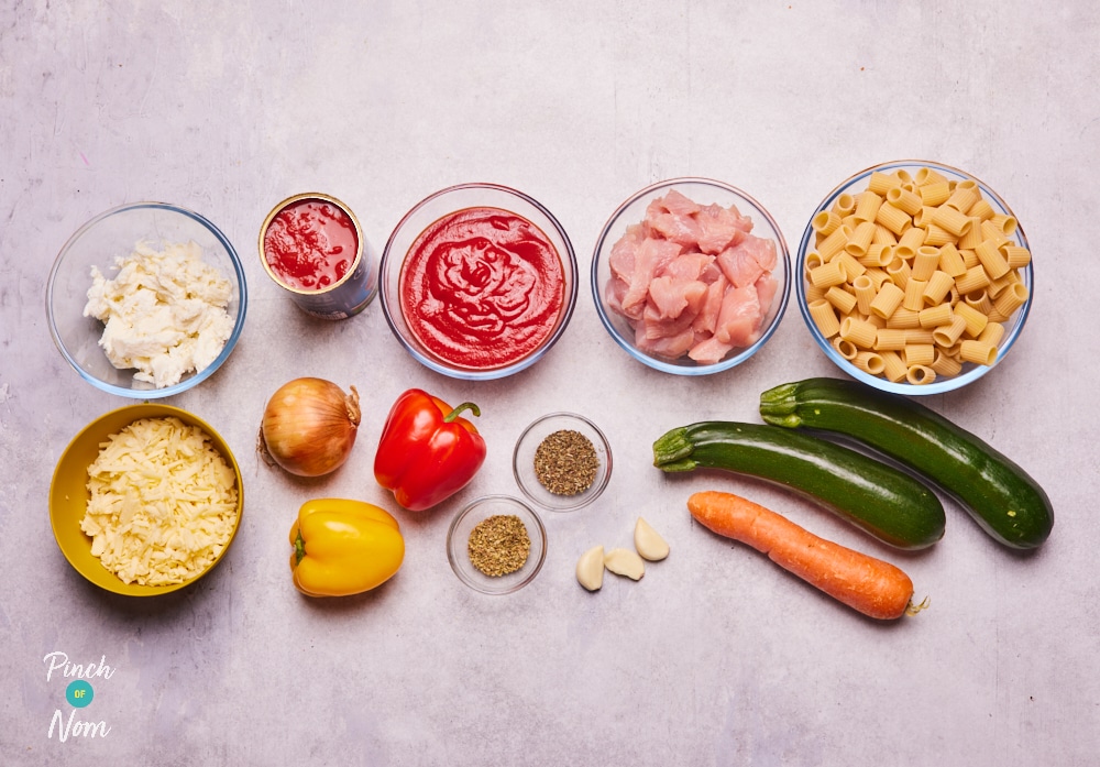 The ingredients for Pinch of Nom's Turkey Ratatouille Pasta Bake are laid out on a kitchen counter, ready to begin cooking.