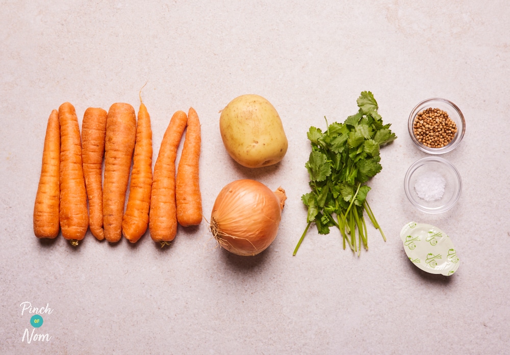 The ingredients for Pinch of Nom's Carrot and Coriander Soup are laid out on a kitchen counter, ready to begin cooking.