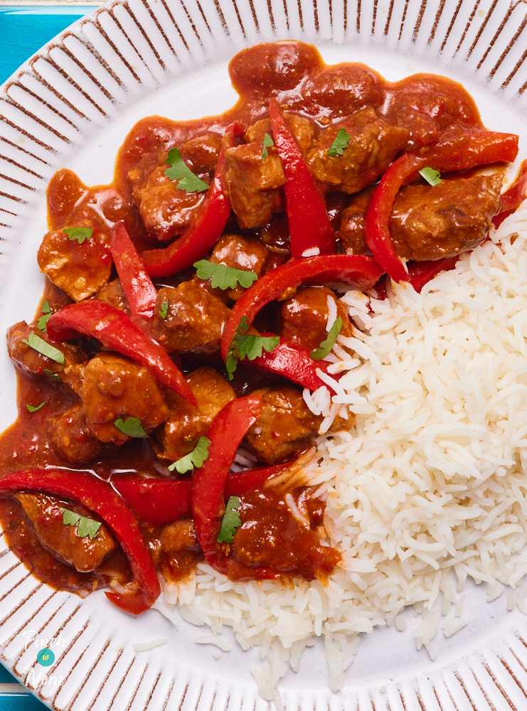 A close-up of Pinch of Nom's Spicy Slow Cooked Pork plated up with a fluffy side of basmati rice.