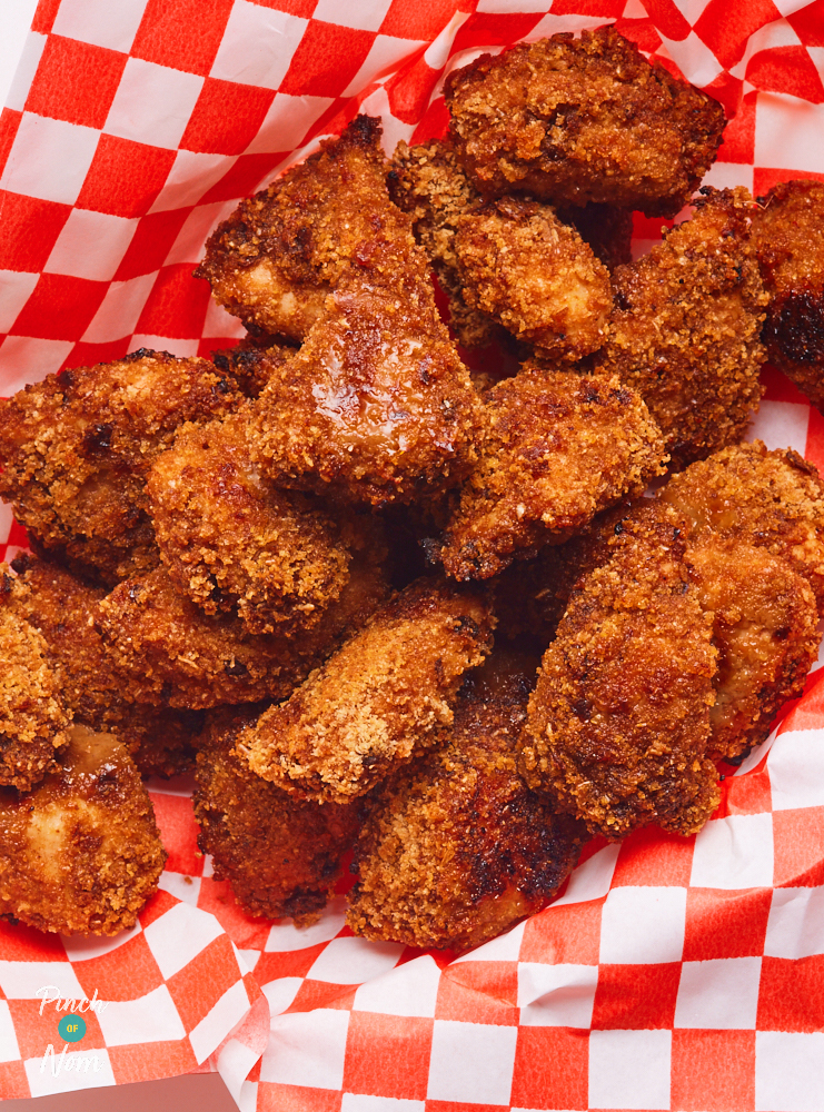 A close-up shot of the golden brown Chipotle Popcorn Chicken in a basket lined with red and white chequered paper.