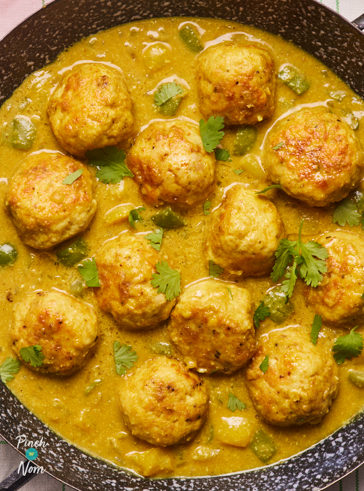 A close-up of Pinch of Nom's Korma Meatballs shows the golden brown meatballs in a creamy sauce, sprinkled with fresh, chopped coriander.