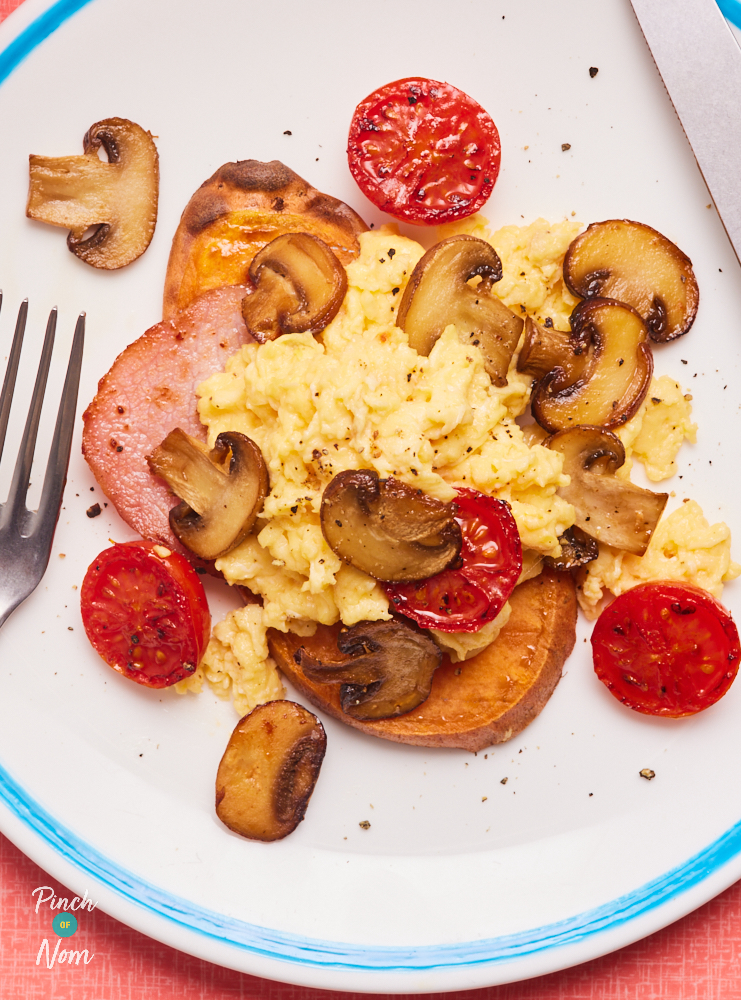 A close-up image of Pinch of Nom's Sweet Potato Breakfast Toast, topped with eggs, mushrooms, bacon and tomatoes.