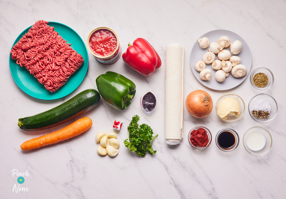 The ingredients for Pinch of Nom's Bolognese and Garlic Swirl Pie are set out on a kitchen counter, ready to make.