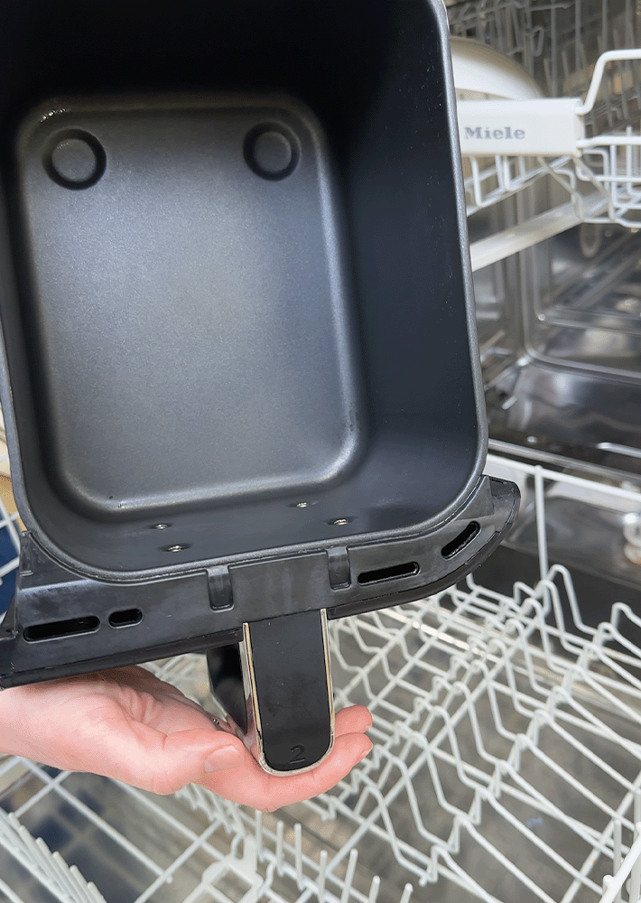 An air fryer drawer is clean and dry from the dishwasher, ready to be replaced in the air fryer main unit.