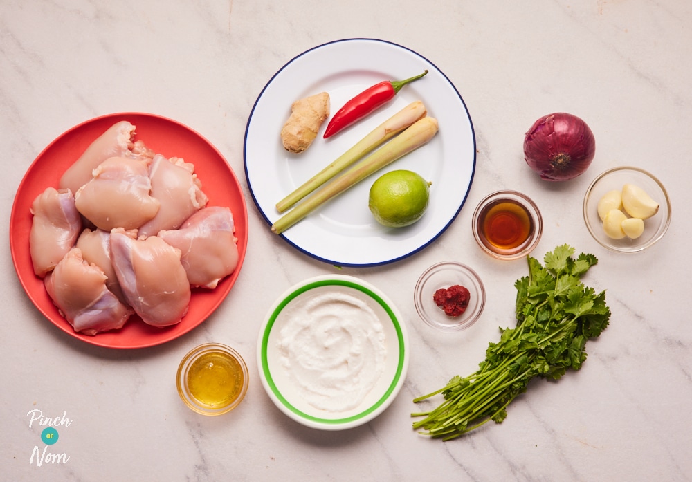 The ingredients for Pinch of Nom's Thai-Style Aromatic Baked Chicken are set out on a kitchen counter, ready to get cooking.