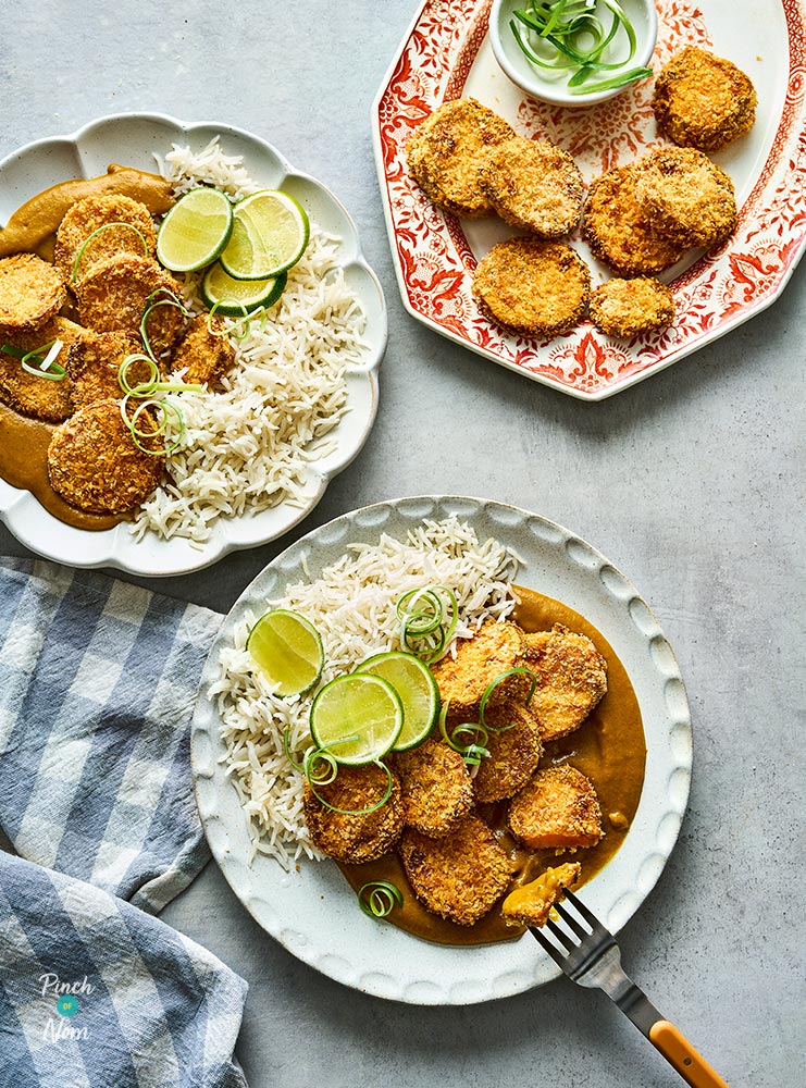 Two plates of Pinch of Nom's slimming-friendly Air Fryer Sweet Potato Katsu are served with basmati rice and a garnish of fresh limes.