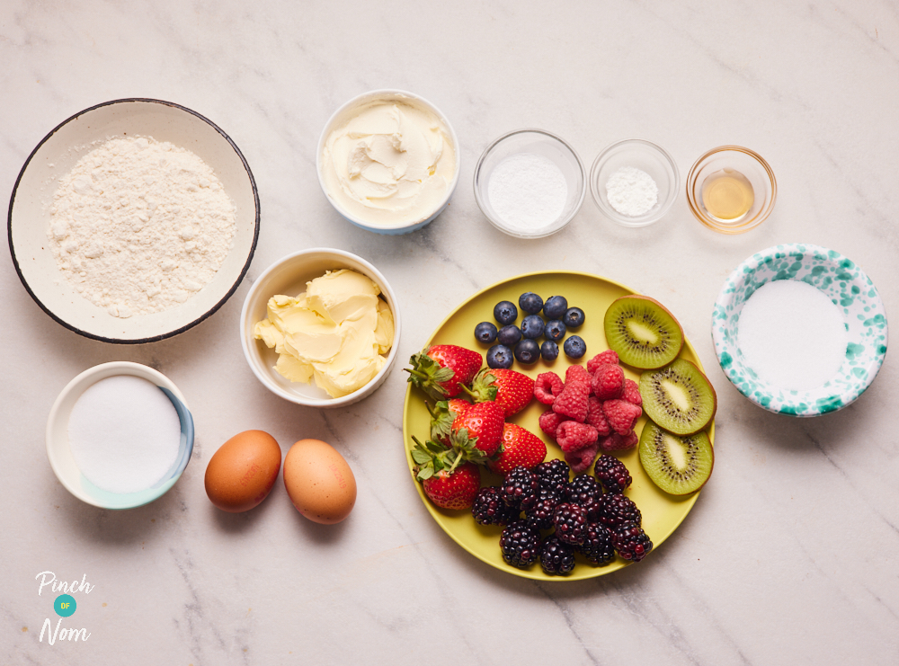 The ingredients for Pinch of Nom's Fruity Cupcakes are laid out on a kitchen counter, ready to bake.