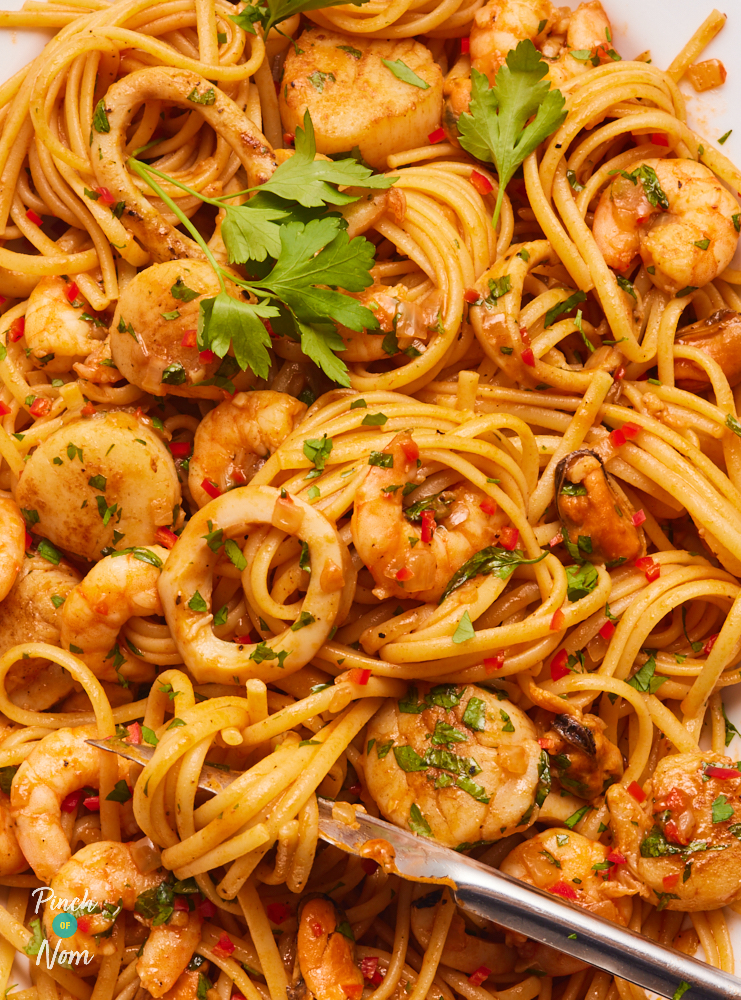 A close-up image of Pinch of Nom's Seafood Marinara Linguine with flat-leafed parsley on top.