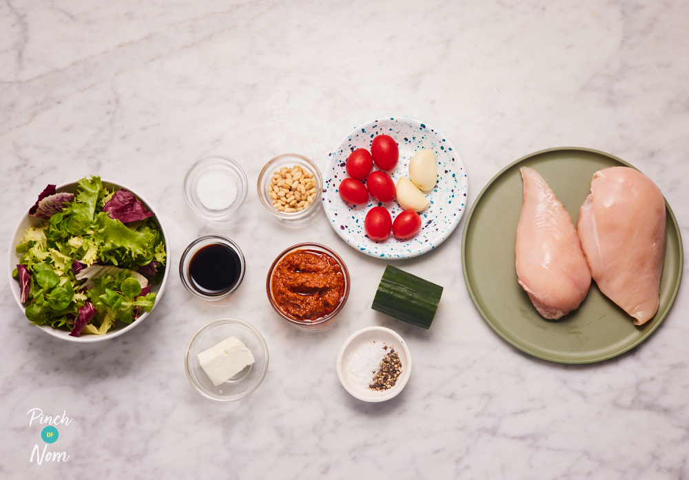 The ingredients for Pinch of Nom's Red Pesto Chicken Salad are laid out on a kitchen counter, ready to begin cooking.