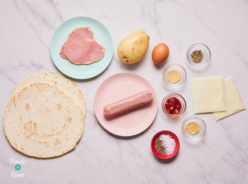 The ingredients for Pinch of Nom's Breakfast Wrap are laid out on a kitchen counter. All the ingredients are measured out, waiting in small glass bowls, ready to begin cooking.