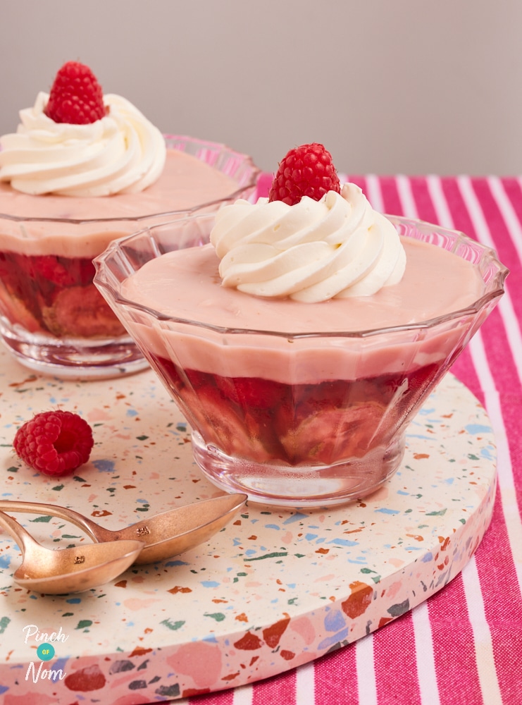 Pinch of Nom's impressive-looking Pink Raspberry Trifles are served in two dishes, topped with a delicate swirl of reduced-fat aerosol cream and a single fresh raspberry.