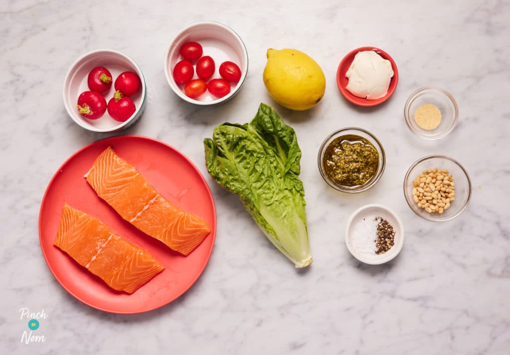 The ingredients for Pinch of Nom's slimming-friendly Salmon Pesto Salad are laid out on a kitchen surface. Each ingredient is measured out, ready to begin cooking.