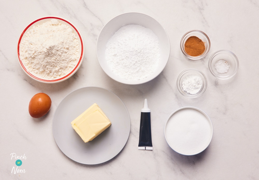 The ingredients for Pinch of Nom's Halloween Skeleton Biscuits are laid out on a kitchen counter, ready to begin baking.