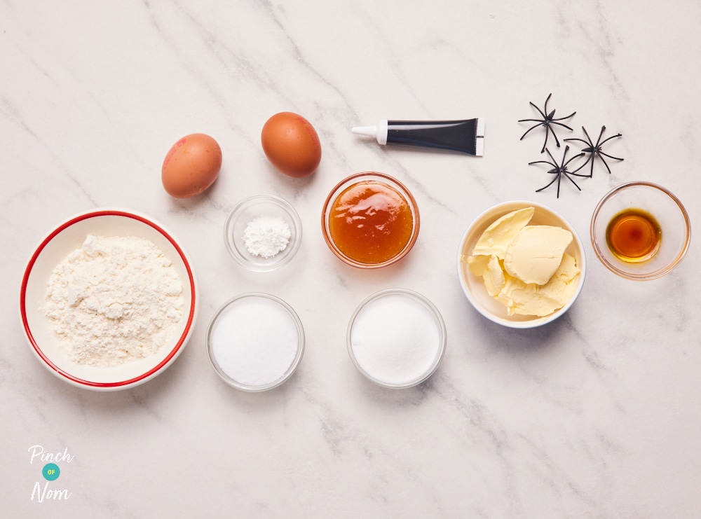 The ingredients for Pinch of Nom's Halloween Spooky Sponge are laid out on a kitchen counter, ready to begin baking.