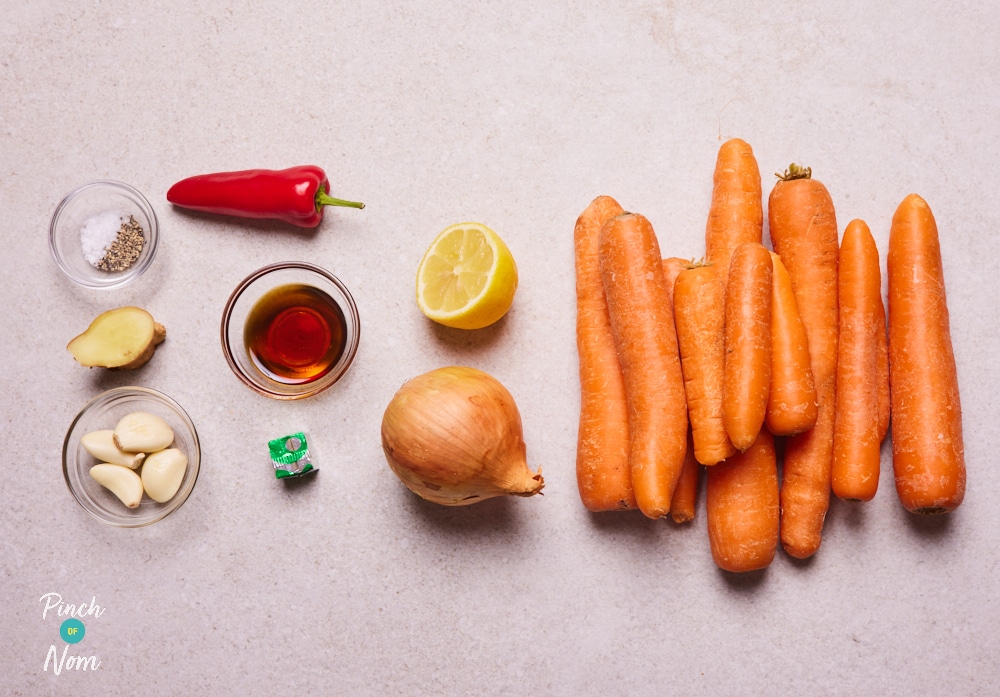 The ingredients for Pinch of Nom's Maple Roasted Carrot Soup are laid out on a kitchen surface, ready to begin cooking.