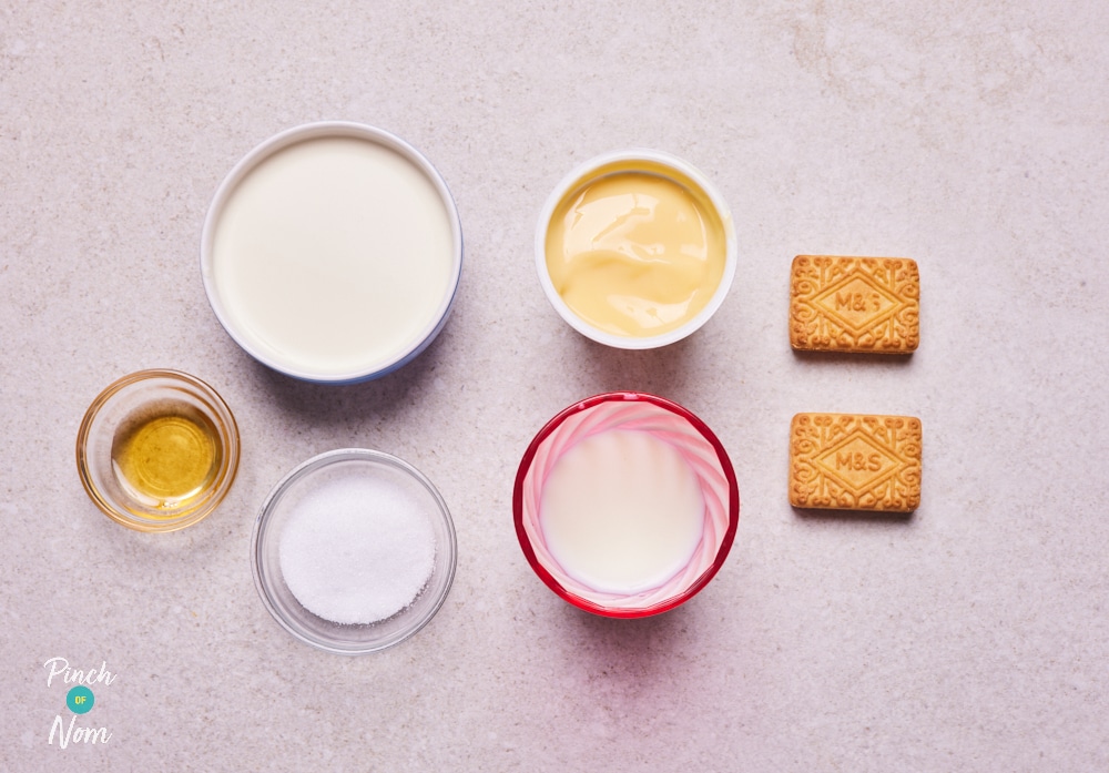 The ingredients for Pinch of Nom's Ninja Creami Custard Cream Ice Cream are laid out on a kitchen counter, ready to be mixed.