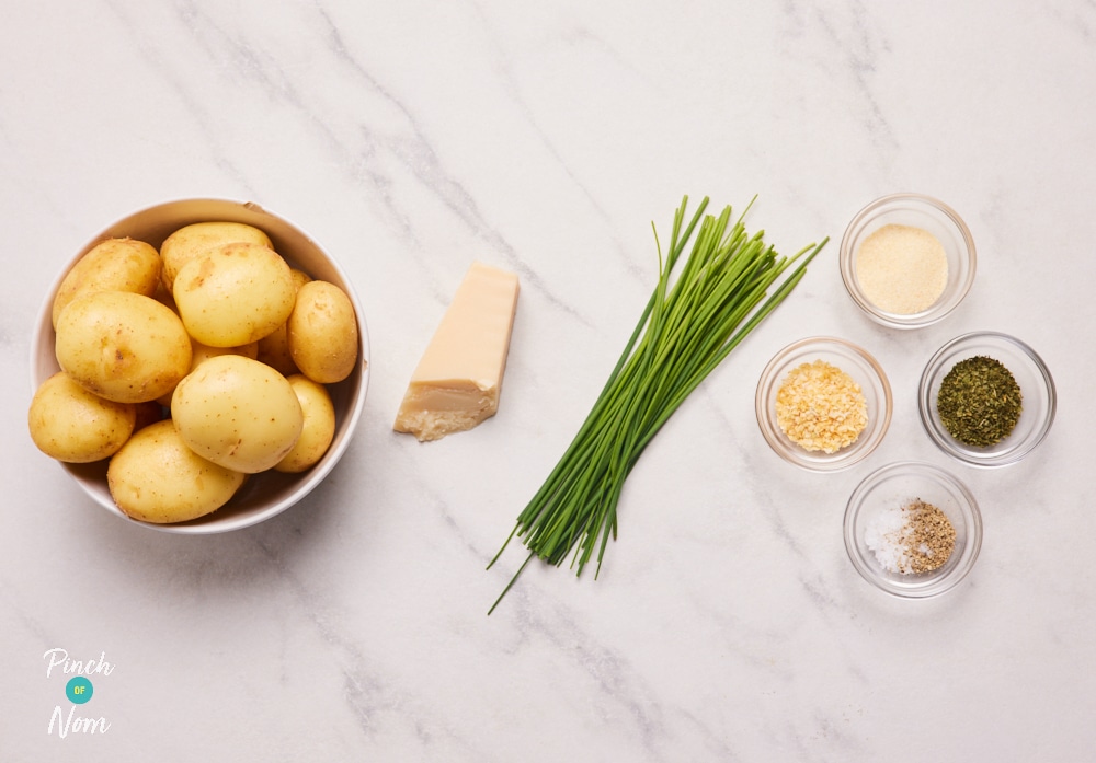 The ingredients for Pinch of Nom's Parmesan Potatoes are laid out on a kitchen surface, ready to begin cooking.