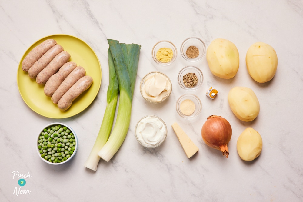 The ingredients for Pinch of Nom's Sausage Tartiflette are laid out on a kitchen counter, ready to begin cooking.