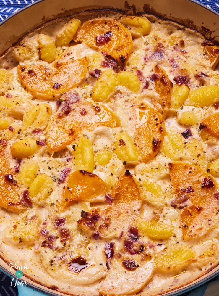 A close up shows Pinch of Nom's Butternut Squash and Sage Gnocchi, fresh from the oven. The top is golden brown.