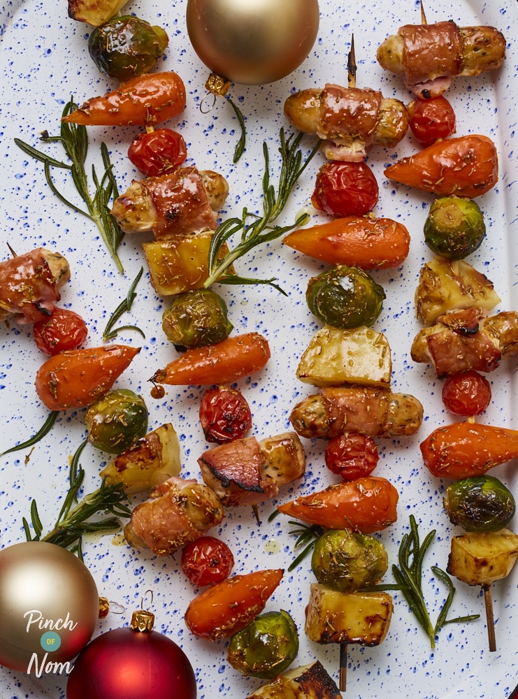 A close up photograph of a serving of Pinch of Nom’s slimming-friendly Pigs in Blankets Skewers recipe