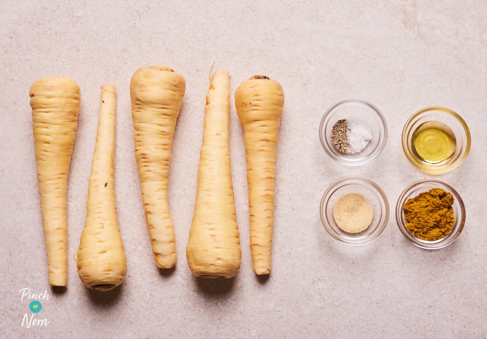 The ingredients for Pinch of Nom's Spiced Parsnip Fries are laid out on a kitchen surface, ready to begin cooking.