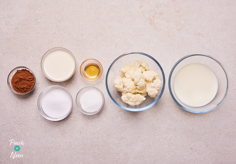 The ingredients for Pinch of Nom's low-calorie NInja Creami Hidden Veg Ice Cream are laid out on a kitchen counter, ready to begin making the recipe.