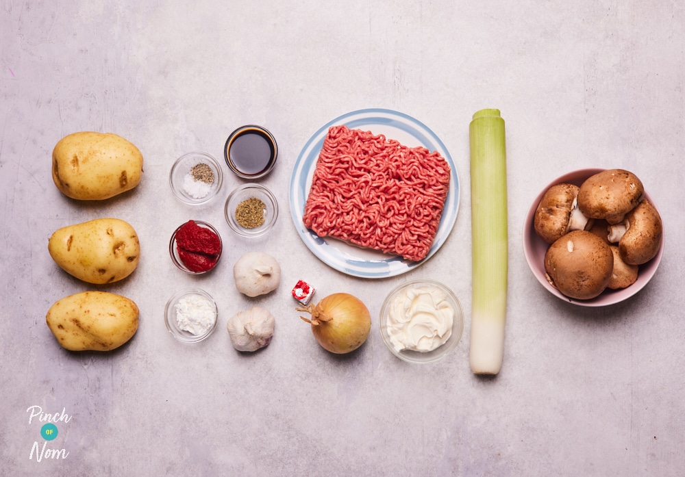 The ingredients for Pinch of Nom's Garlic and Mushroom Cottage Pie are laid out on a kitchen counter, ready to begin cooking.