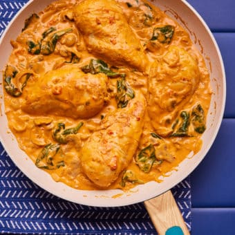 Creamy Red Pesto chicken, cooked in a large frying pan.