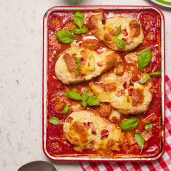 Chicken baked in marinara sauce, topped with vegetables and herbs.