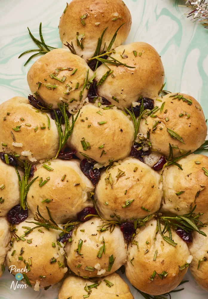 Christmas Dough Balls, freshly baked and topped with rosemary garlic "butter", ready for serving.