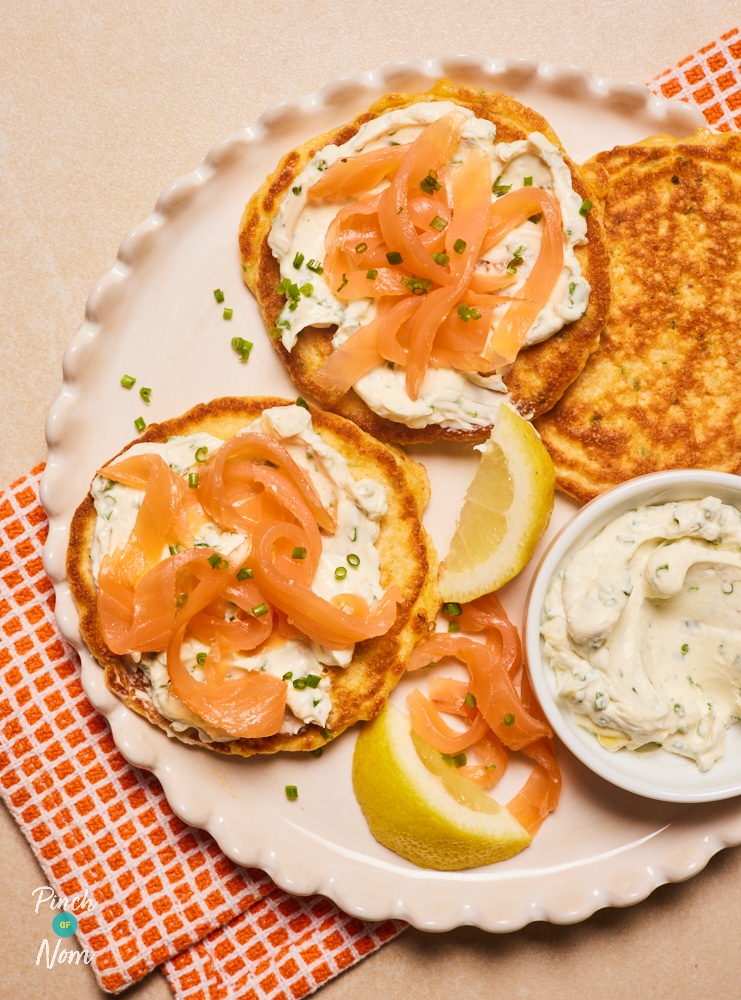 Pinch of Nom Cheese and Chive Pancakes with Smoked Salmon, plated up with a lemon garnish.