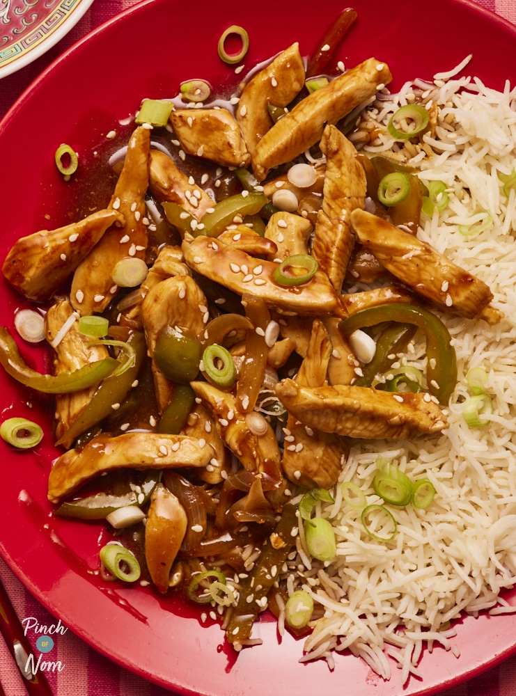 Pinch of Nom Chicken with Peking-Style Sauce, served with fluffy basmati rice and sprinkled with chopped spring onion.