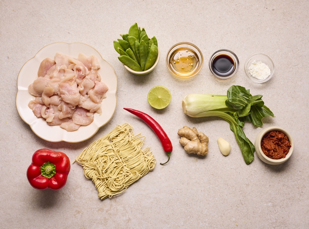 Ingredients for Harissa Chicken Noodle Bowls laid out on counter.