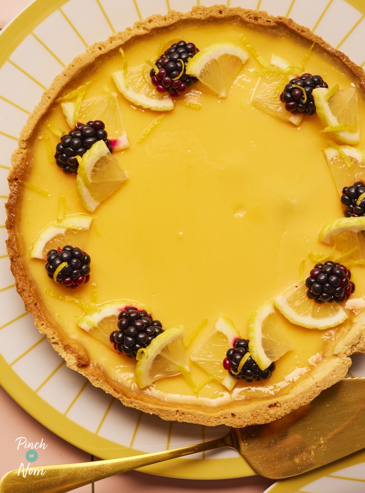 Pinch of Nom Lemon Egg Custard Tart, freshly baked and topped with blackberries and lemon slices.